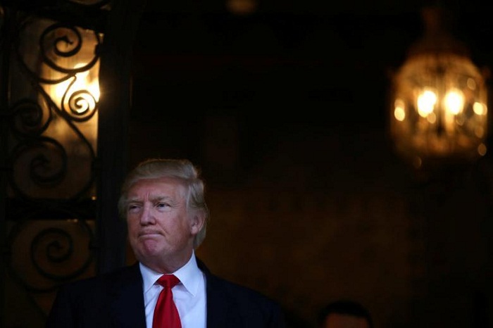 Trump, taking a break from White House prep, tees off with Tiger Woods 